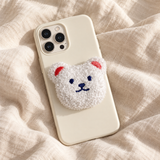 Support de téléphone en peluche ours blanc sur une coque crème — Cocooning